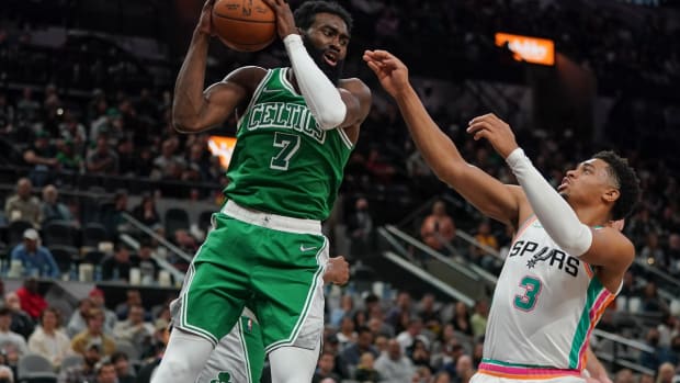 Nov 26, 2021; San Antonio, Texas, USA; Boston Celtics guard Jaylen Brown (7) rebounds in front of San Antonio Spurs forward Keldon Johnson (3) in the second half at the AT&amp;T Center. Mandatory Credit: Daniel Dunn-USA TODAY Sports